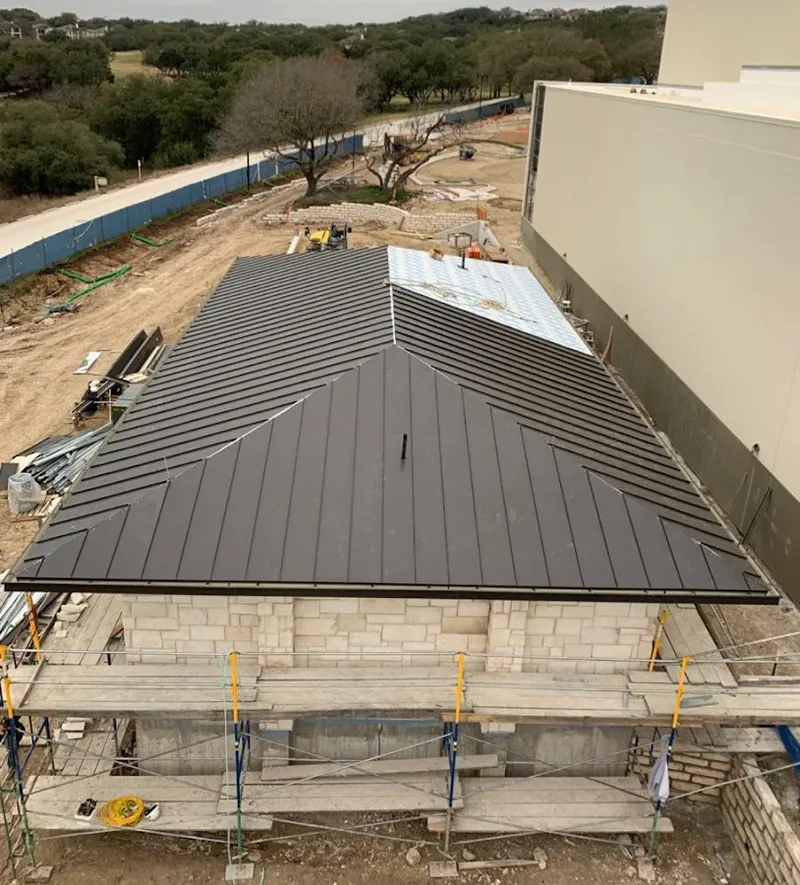 Metal roof new construction with scaffolding in Clifton