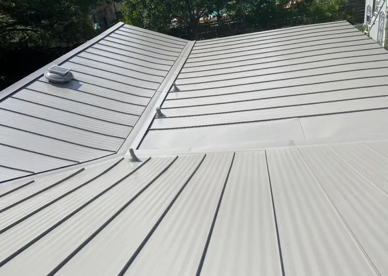 Solar attic fan installed on a metal roof for Roof Ventilation in Clifton